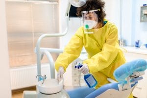 woman cleaning dentist office-min